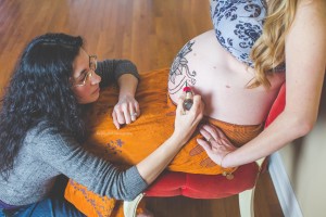 Prenatal belly henna designs require focus and a steady hand to create.