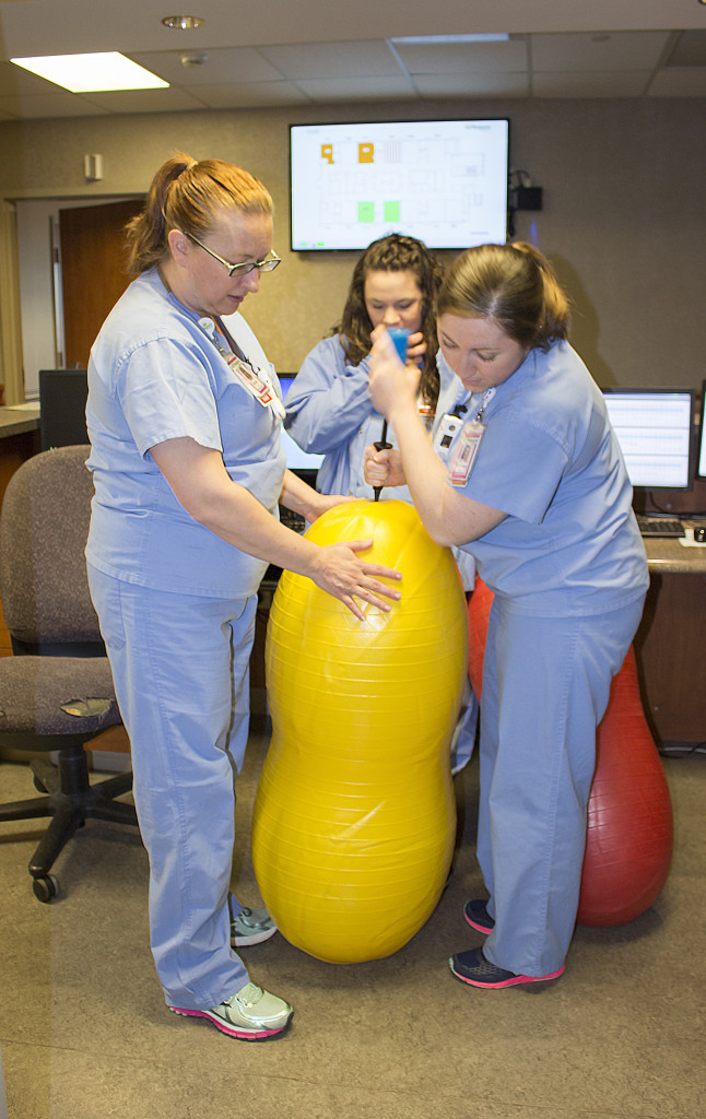 Nurses inflating a large peanut ball